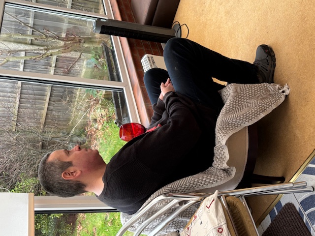 Photo of Martin sitting in conservatory.